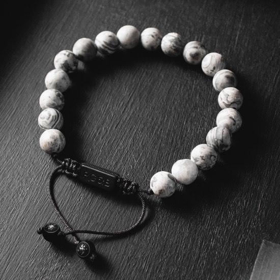 Grey Jasper Bead Bracelet - Our Grey Jasper Bead Bracelet Features Natural Stones, Waxed Cord and Brushed Black Steel Hardware. A Beautiful Addition to any Collection.